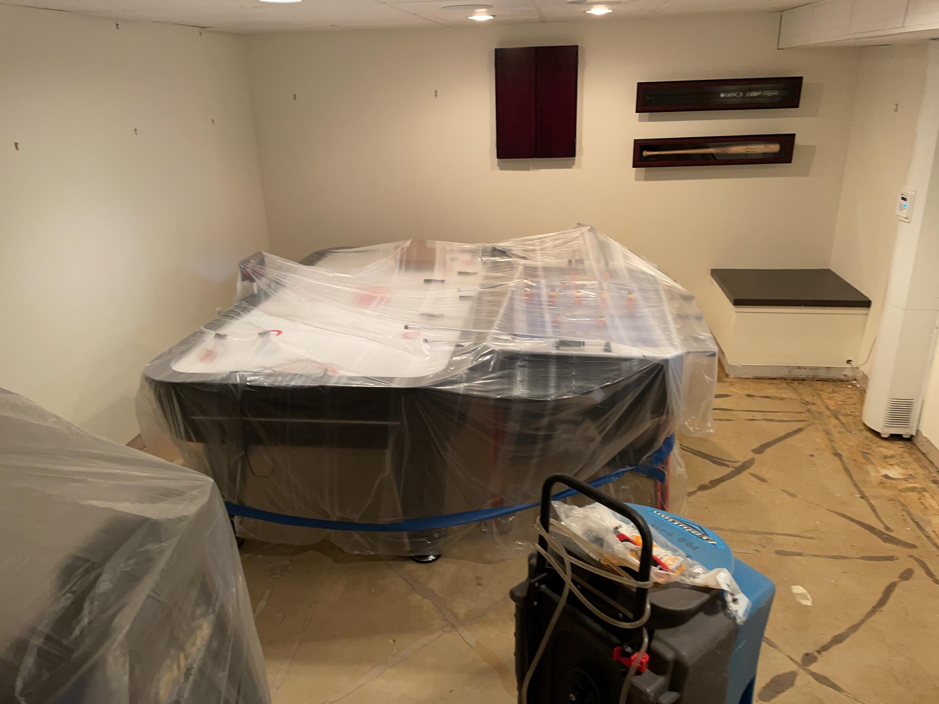 Unaffected items covered and protected, rug removed, drying out area
