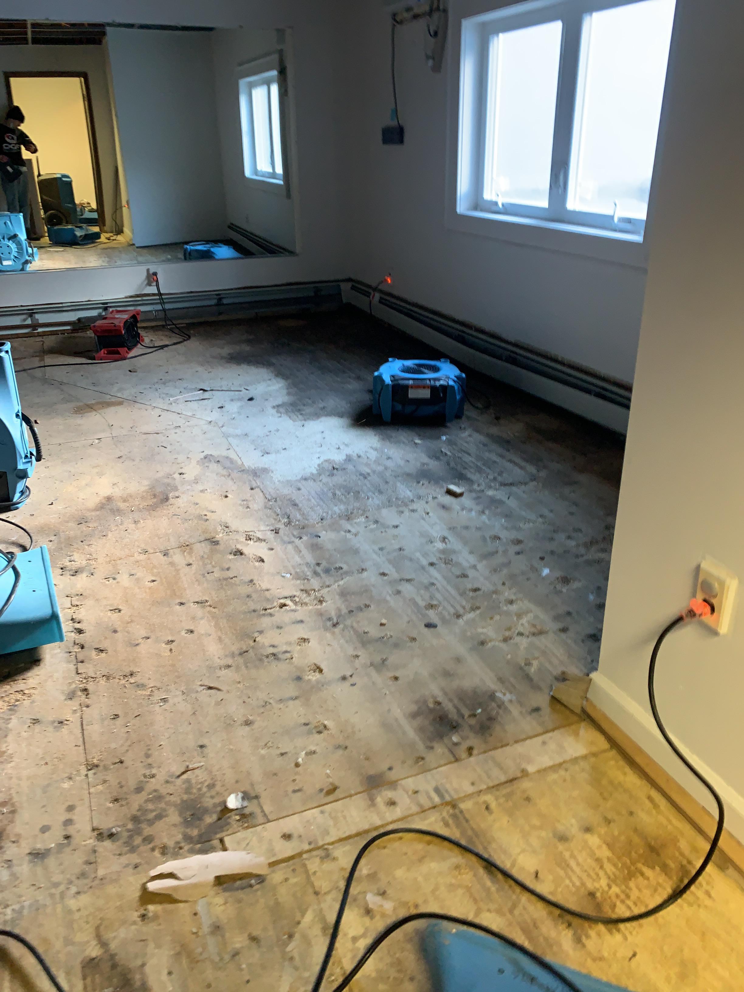 Drying equipment setup to dry wet wood subfloor.