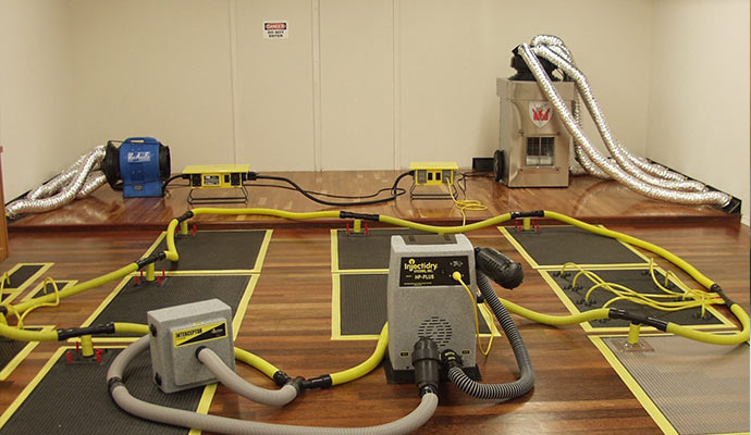 Extracting water from damaged wooden floor